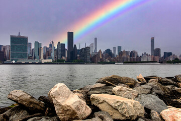 The skyline of the Big Apple with a rainbow seen from the cliff of Long Island which is an island...