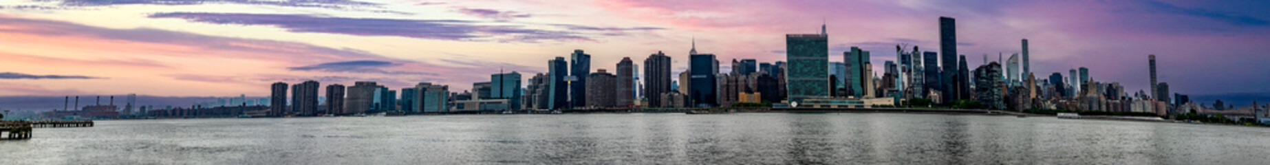 Great panoramic view of the Big Apple skyline seen at sunset from Long Island which is an island...