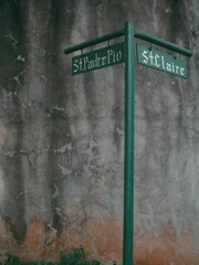 Street sign indicating that St Padre Pio and St. Claire streets are near