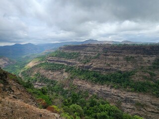 an area with hills and a river on both sides of it