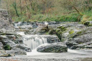 Long exposure of beautiful waterfalls cascading down a steep, rocky mountainside