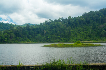 Situ gunung lake in indonesia. Forest lake under cloudy sky