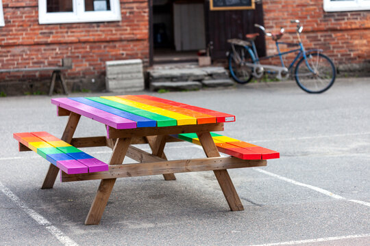 Multi colored bench kept on footpath