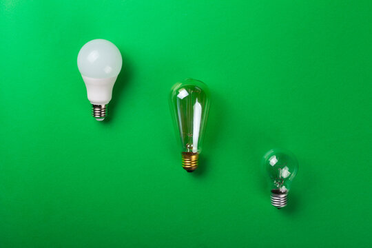 Led lamp or incandescent lamp, edison lanp on isolated green background. Flat lay. Concept ecology, save planet earth, idea, save energy, economy, saving. Earth day. Smart shopping, sale, buy.
