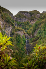 Remote waterfall cascades over mountainside.