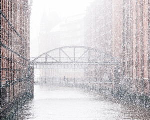 Hamburg, Germany: snow falling over the city warehouse area with  bridge in winter