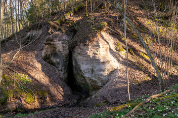 landscape with sandstone rock outcrop and cave, devil's cave near Vaidavmuiza, Valmiera county,...