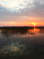 Fototapeta premium Sunset against the backdrop of a glassy lake