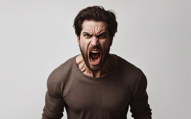 Fototapeta premium Portrait of a man who is screaming furiously, his face expresses anger and anger, his mouth and eyes are wide open.
