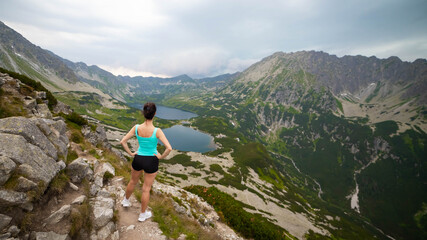 Hikers descending from Mount Rysy to Czarny Staw or Black Lake in Tatra mountains, one of the most popular alpine hiking trails in Zakopane, Poland