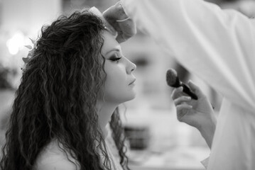 portrait of a bride with green curly hair in the beauty room