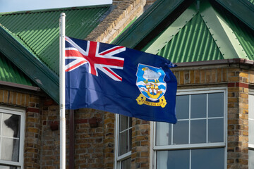 The Falkland Islands flag on a pole in Stanley harbor, Falkland Islands (Islas Malvinas), UK