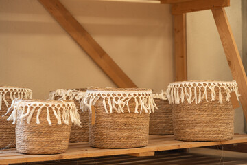 Three Decorative Woven Baskets on Shelf
