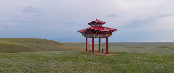 A national-style gazebo in the steppe on a cloudy June evening. Republic of Kalmykia, Russia
