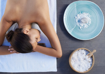 Sleeping, salt or woman in spa or resort with bowl for wellness, treatment or hospitality. Relax,...