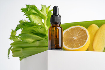 Mockup of green serum oil extract made of ginger and lemon in dropper bottle with pipette on white...