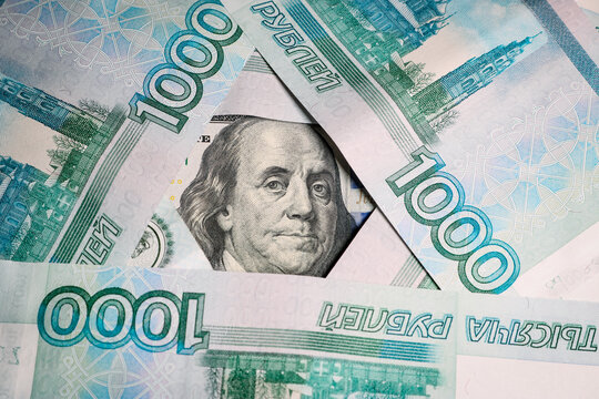 A portrait of American President Franklin on a banknote among Russian 1000 ruble bills.