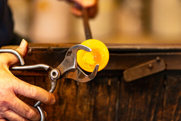 Glass master working in front of the furnace in Murano Island in Venice Italy