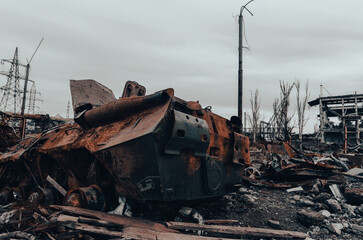 burnt tank and destroyed buildings of the Azovstal plant shop in Mariupol