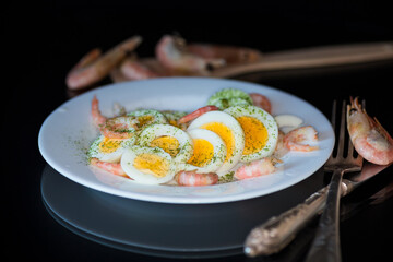 boiled eggs with boiled shrimp in a plate for breakfast