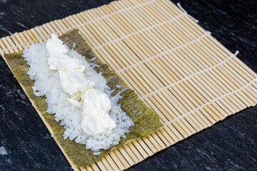 preparing sushi at home, homemade gourmet salmon roll