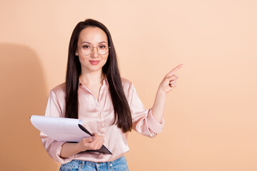 Photo of positive girl wear pink shirt in glasses hold checklist indicating at discount empty space...