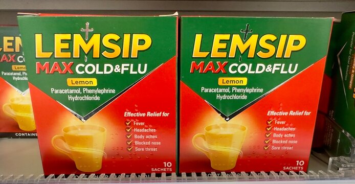 Essex, UK - January 19, 2024: Boxes of Lemsip sachets max cold and flu paracetamol, phenylephrine, hydrochloride pain relief on sale in a British shop. 