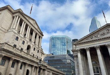 A partial view of the Bank of England and the Royal Exchange with modern buildings in the background skyline in the City of London, England. 