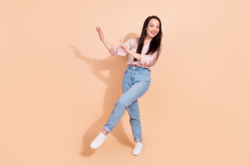 Fototapeta na wymiar Full length photo of positive cheerful girl wear pink shirt jeans pants dancing having fun at party isolated on pastel color background