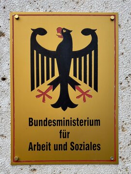 Berlin, Germany - November 7, 2023: Sign for the German Federal Ministry of Labour and Social Affairs on the wall of a government building in Berlin, Germany. 