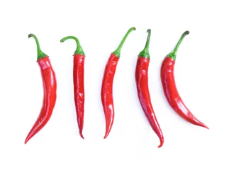 Fotobehang Chilli red peppers in line isolated on white background. Long red hot peppers, aligned. Cayenne peppers © DesignToonsy