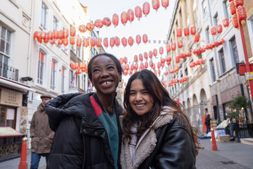 Portrait of two cheerful women in Chinatown