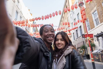 Fotobehang Portrait of two cheerful women in Chinatown © Cultura Creative