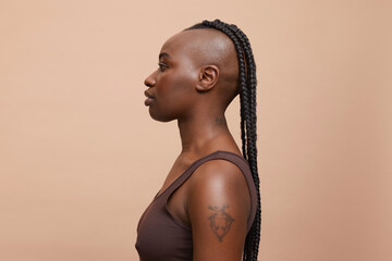 Profile portrait of beautiful woman with mohawk hair