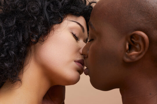 Studio portrait of lesbian couple kissing