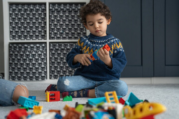 Boy (2-3) playing with toy blocks at home