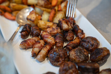 Close-up of roasted vegetables and meat on Christmas dinner table