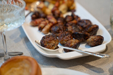 Close-up of roasted vegetables and meat on Christmas dinner table
