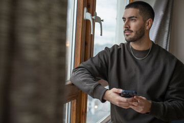 Young man using smart phone at home © Cultura Creative