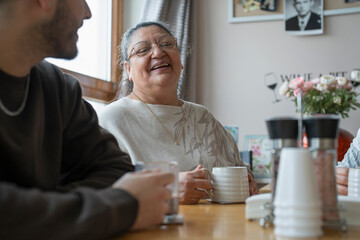 Grandmother and grandson drinking tea at home