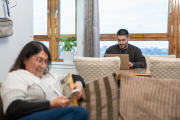 Mother and son sitting in living room