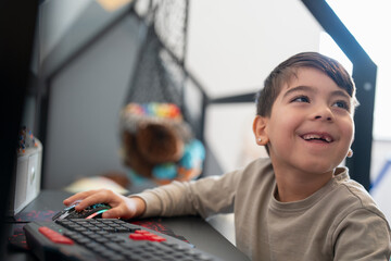 Boy (6-7) using computer at home