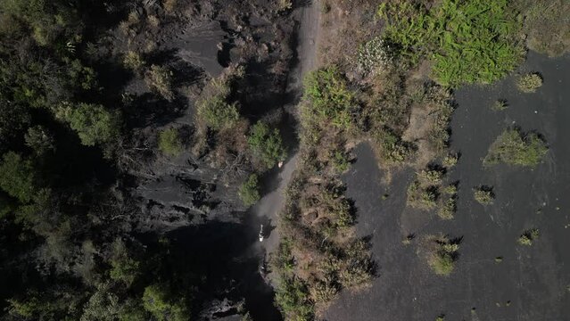 Aerial view of people riding horses on a trail in the volcanic fields near Paricutin volcano, Mexico