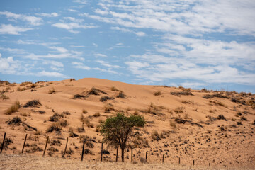Fototapeta na wymiar magical beauty yellow mountains and a desert plain against the sky in the Namibian desert