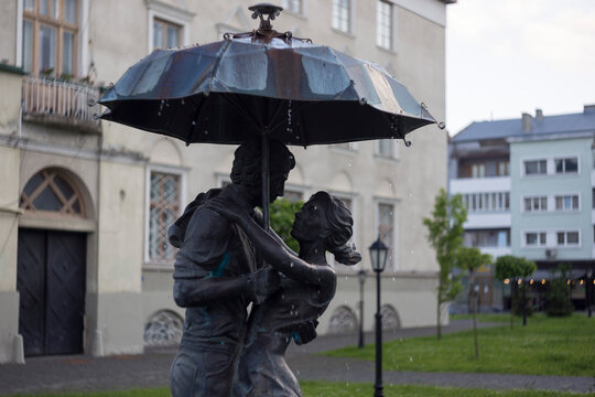 DROHOBYCH, UKRAINE - June 15, 2023: A fountain sculpture on Rynok Square, Couple in love, Heavy blizzard in the city