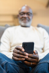 Obraz na płótnie Canvas Close-up of senior man using smart phone