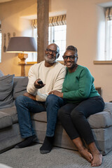 Senior couple watching TV at home