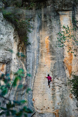 Fototapeta premium A climber in action is climbing the mountain 