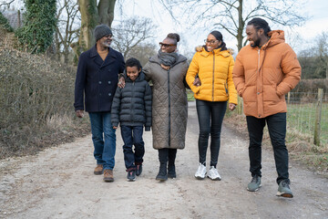 Three generation family walking together in rural area