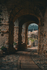 old stone arch in the castle with the beautifull view on the background, Italy